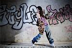 Female Hip Hop Dancer in Front of Wall of Graffiti