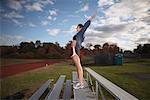 Woman Exercising on Bleachers