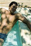 Man relaxing in swimming pool, eyes closed