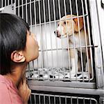 Woman with Dog in Cage