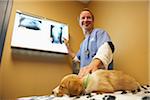 Veterinarian Looking at X-Rays of Dog