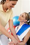 Physiotherapist Examining Woman's Arm