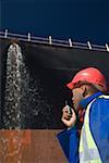 A harbour worker using a walkie talkie