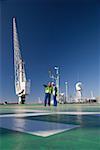 Two harbour workers on a ship deck