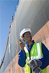 A harbour worker using a walkie talkie