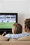 Rear view of a couple watching tv