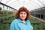 Woman Standing in Greenhouse