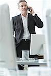 Businessman with Cellular Phone in Office