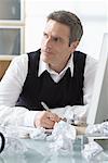 Businessman Sitting at Desk Writing