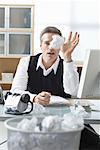 Businessman Sitting at Desk Writing