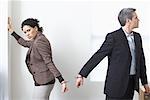 Businessman and Businesswoman Handcuffed Together