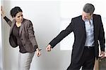 Businessman and Businesswoman Handcuffed Together