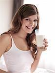 Woman with Milk Moustache Holding Glass of Milk