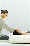 Woman receiving reiki head massage