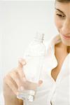 Woman holding bottle of water, cropped view