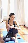 Woman on Yoga Mat with Bowl of Fruit