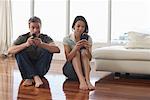 Couple with Cellular Phones in Condominium