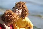 Young red-headed brothers on a beach.