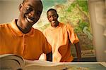 Portrait of twin teenage brothers in a classroom.