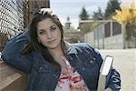 Teenage girl standing in the schoolyard.