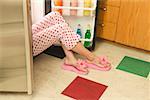 Woman sitting in an open refrigerator.