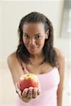 Young woman holding an apple.