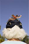 Rear view of senior woman wearing vintage hat.