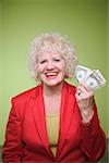 Senior woman holding a handful of money.