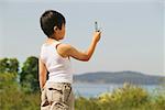 Young boy taking a photo with his mobile phone