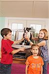 Three kids photo copying a dog