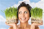 Woman holding pots of wheat grass