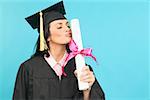 A female graduate kissing her diploma