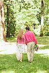 Newlywed couple walking through a park