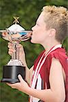 Boy holding and kissing a trophy