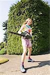 Woman with a power hedge trimmer