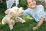 Boy and dog playing together outdoors