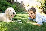 Boy and dog together outdoors
