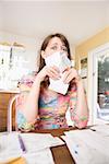 Woman sorting through bills at home