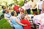 Family preparing to sit down at picnic