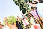 Family with upraised arms at picnic