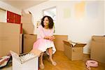 Woman in new home with moving boxes