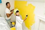 Man and child painting wall