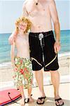 Boy posing with dad on beach