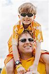 Little boy riding on dad's shoulders