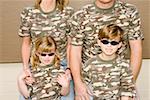 Young children with parents in camouflage