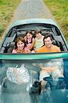 Family in convertible with top down