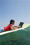 Little girl using laptop while surfing