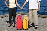 Couple with luggage waiting on pier