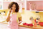 Woman talking on phone in kitchen