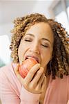 Closeup of woman biting into apple